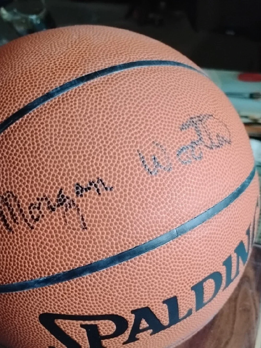 Spalding Orange Basketball with Black Logo Autographed by a Legend Head Coach